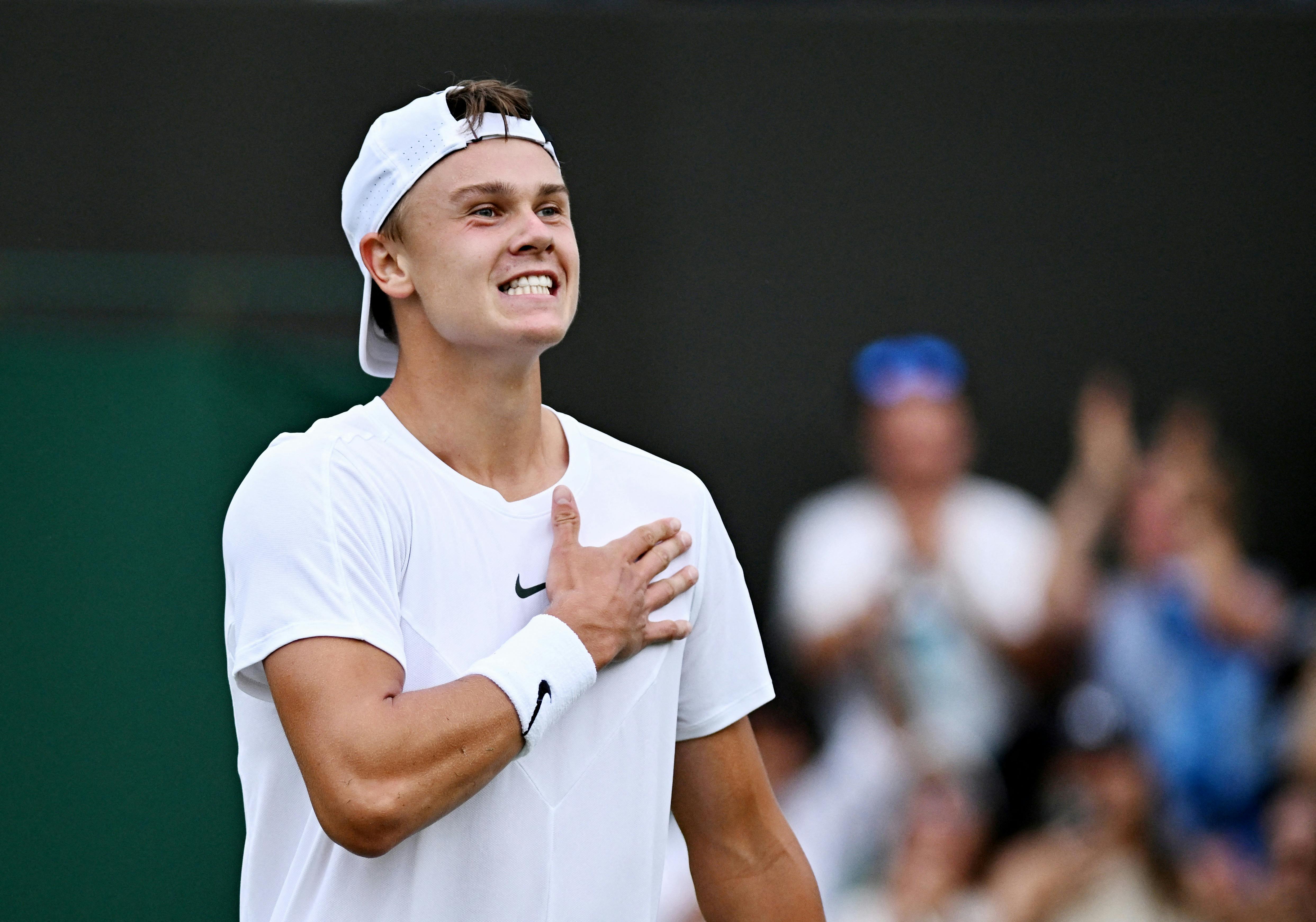 Tennis - Wimbledon - All England Lawn Tennis and Croquet Club, London, Britain - July 8, 2023 Denmark's Holger Rune celebrates after winning his third round match against Spain's Alejandro Davidovich Fokina REUTERS/Dylan Martinez