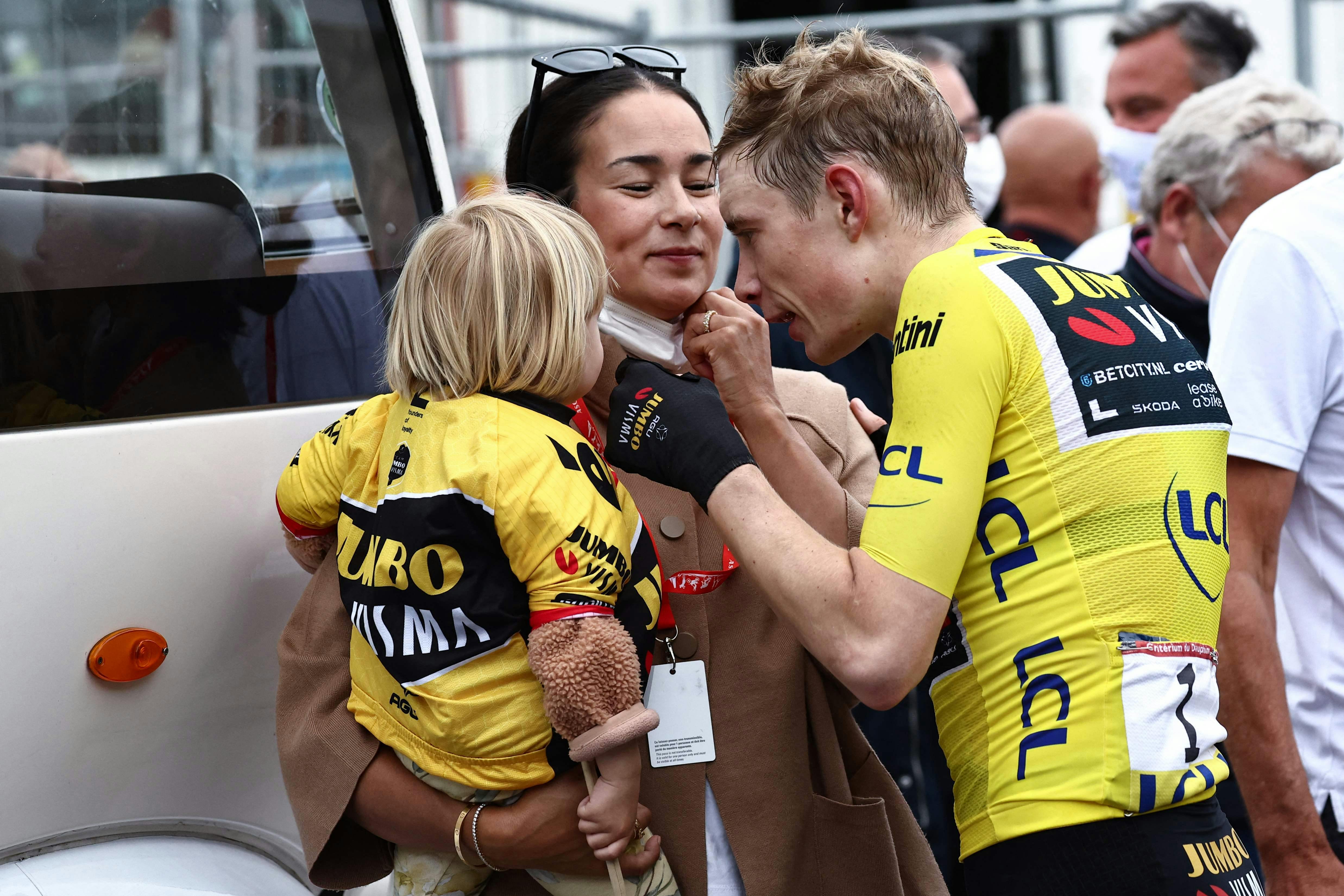 Wearing a Yellow Jersey of Overall Leader, Jumbo-Visma's Danish rider Jonas Vingegaard (R) talks to his partner Trine Marie Hansen (C) and their daughter Frida (L) after the sixth stage of the 75th edition of the Criterium du Dauphine cycling race, 170, 5km between Nantua to Crest-Voland, France, on June 9, 2023. (Photo by Anne-Christine POUJOULAT / AFP)
