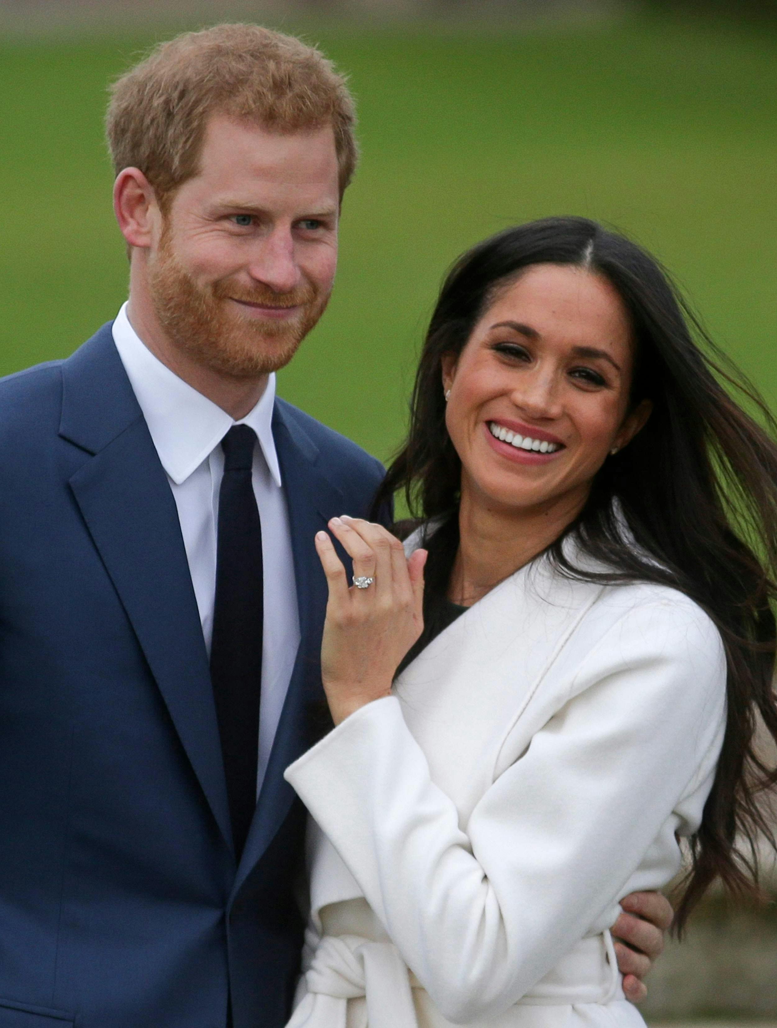 Prince Harry stands with his fiancée US actress Meghan Markle