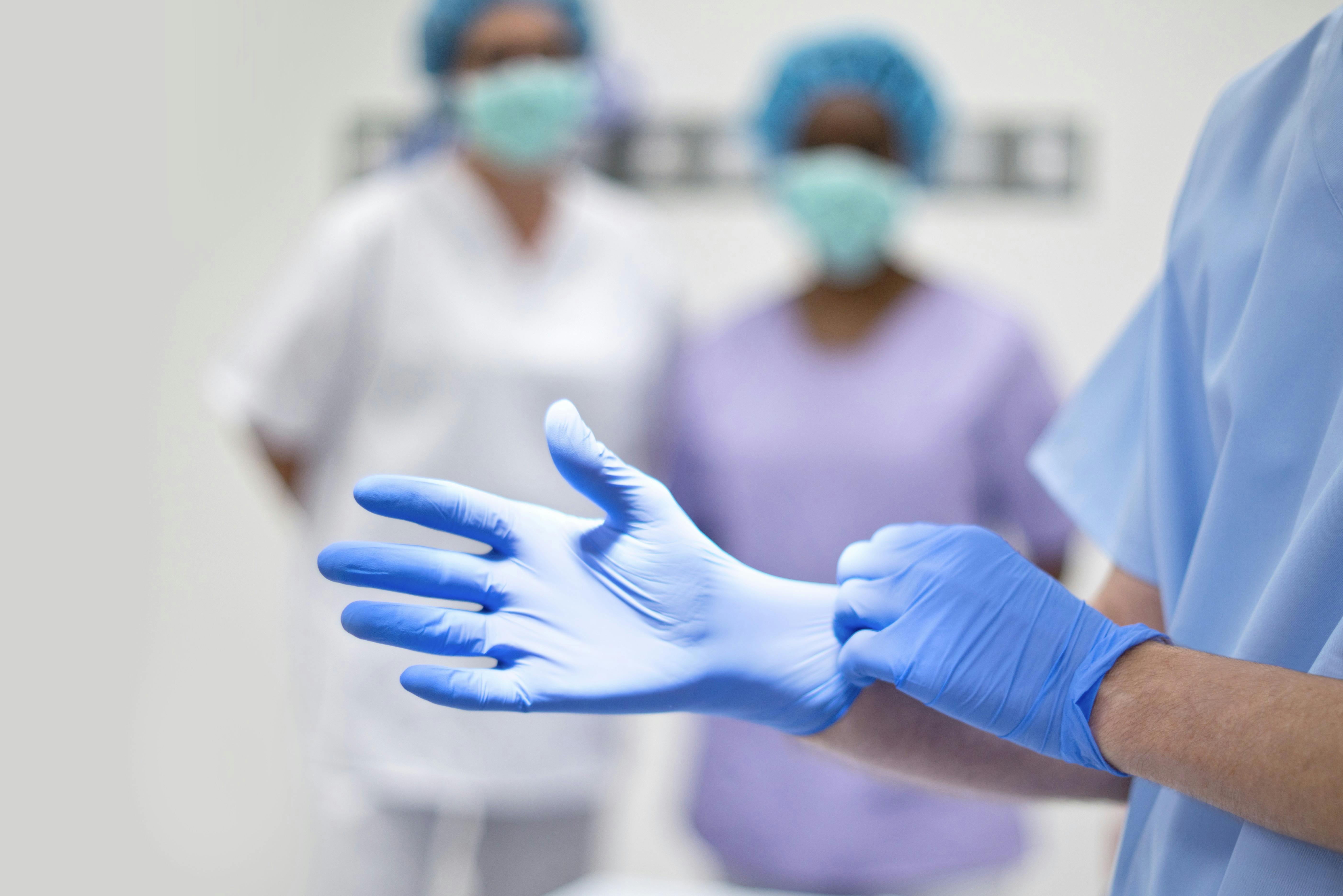  Surgeon putting on latex glove