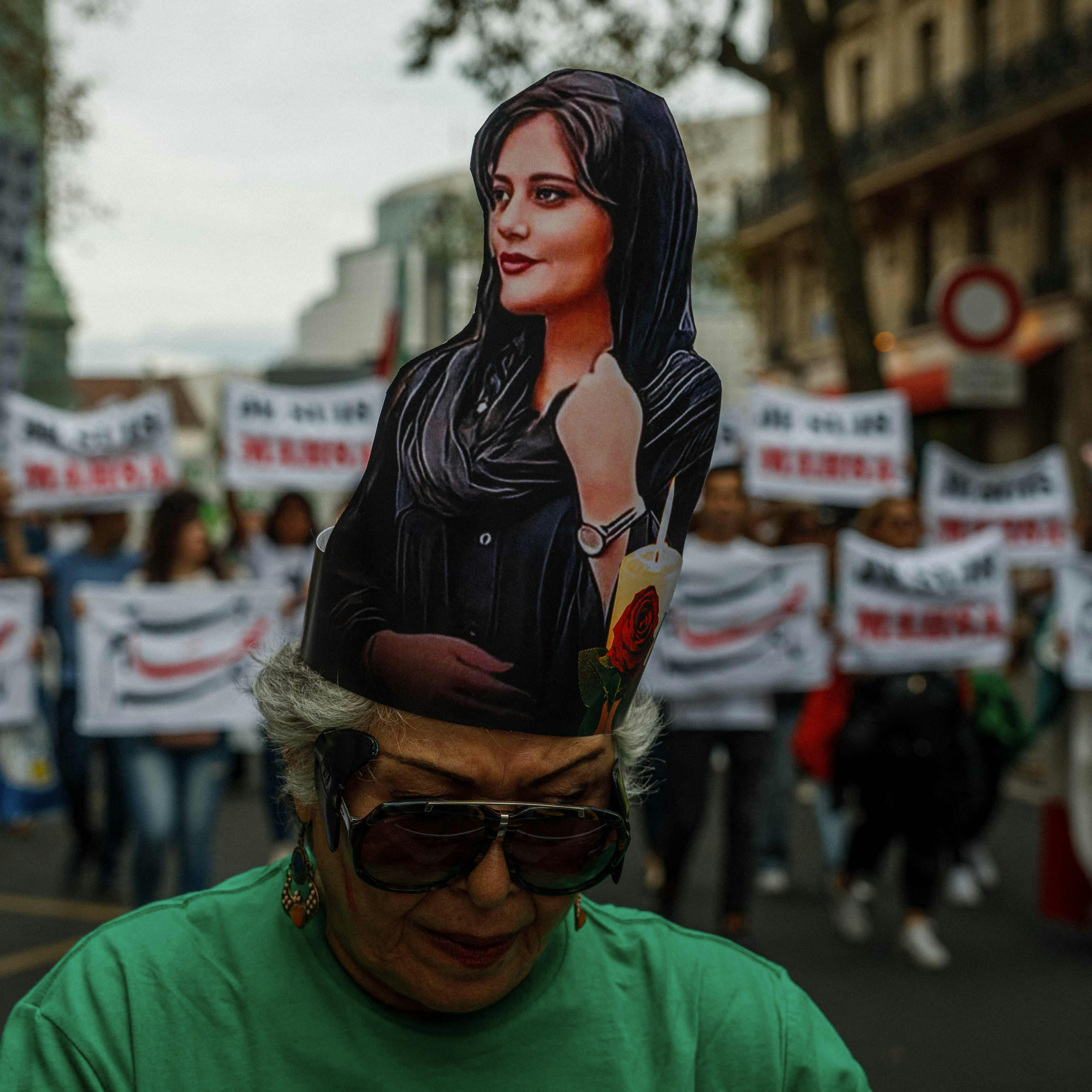 TOPSHOT - Demonstrators attend a protest against the Iranian regime at Place de la Bastille in Paris on September 16, 2023, on the first anniversary of the death of Mahsa Amini in Iran. Mahsa Amini, a 22-year-old Iranian Kurd, died in police custody on September 16 last year following her arrest for an alleged breach of the Islamic republic's strict dress code for women. (Photo by Dimitar DILKOFF / AFP)