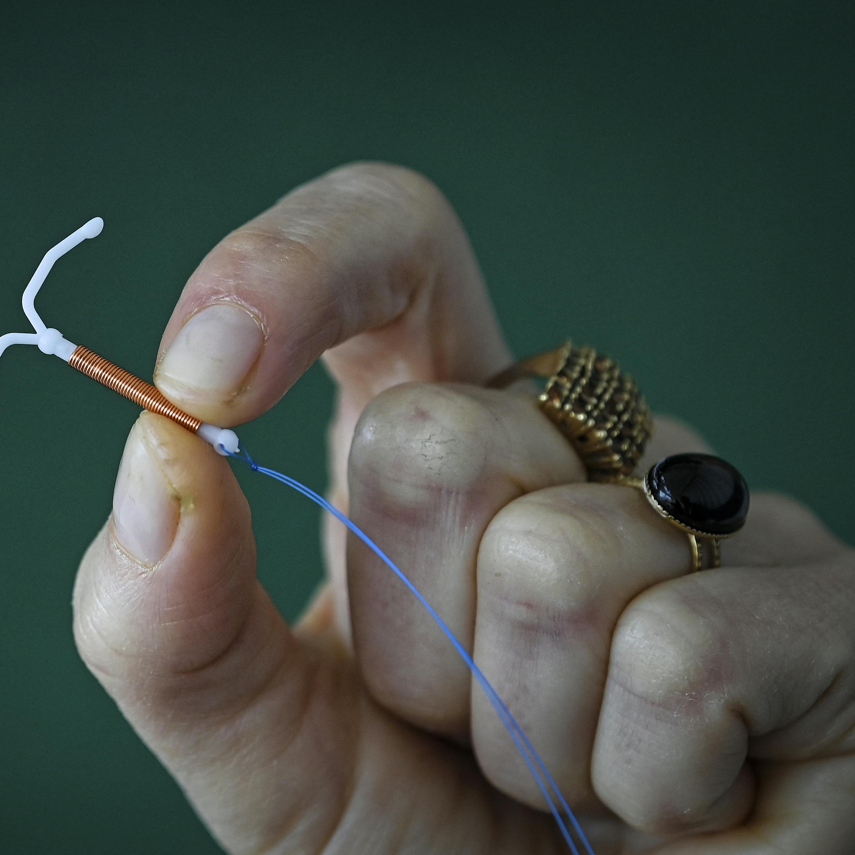 This photograph taken on March 30, 2023, shows a copper IUD (intrauterine device) in Toulouse, southwestern France. Valentine CHAPUIS / AFP