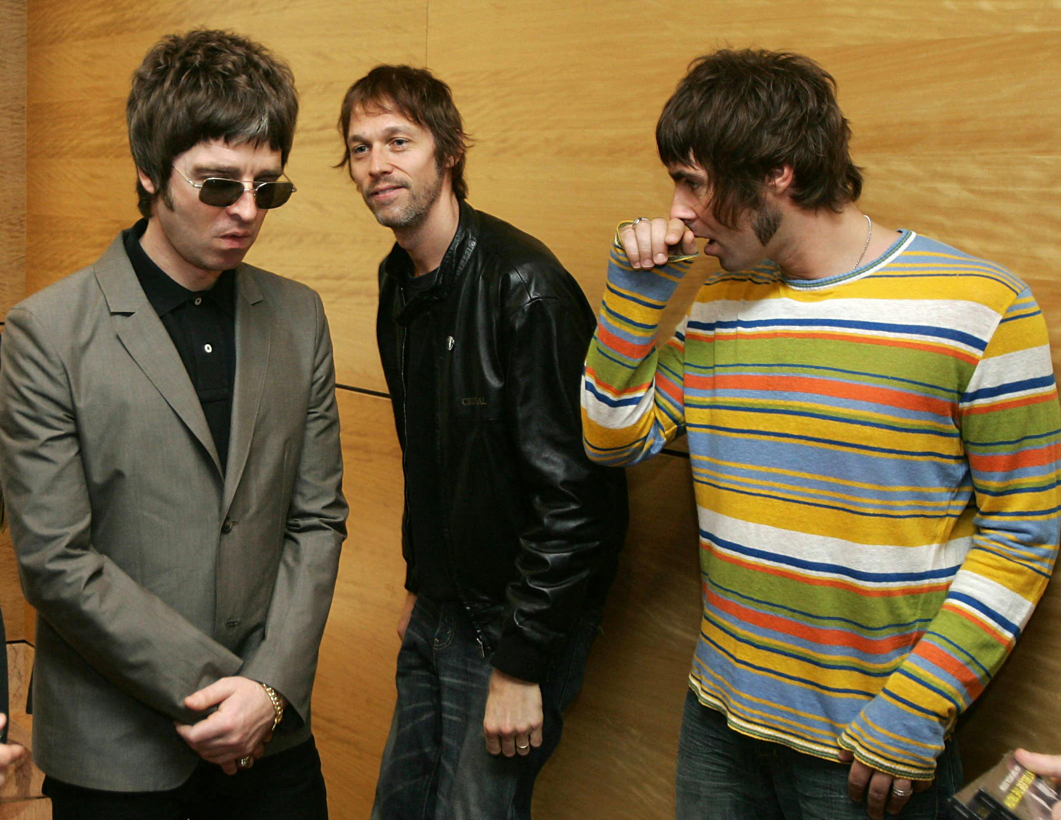 (FILES) Noel Gallagher (L) Andy Bell (C) and Liam Gallagher, members of the British rock band "Oasis" hold a photocall in Hong Kong on February 25, 2006. Fans of British rock band Oasis buzzed with anticipation on Monday, August 26, as Liam and Noel Gallagher teased that they could be returning to stage together, fifteen years after the band's last performance. (Photo by Mike CLARKE / AFP)