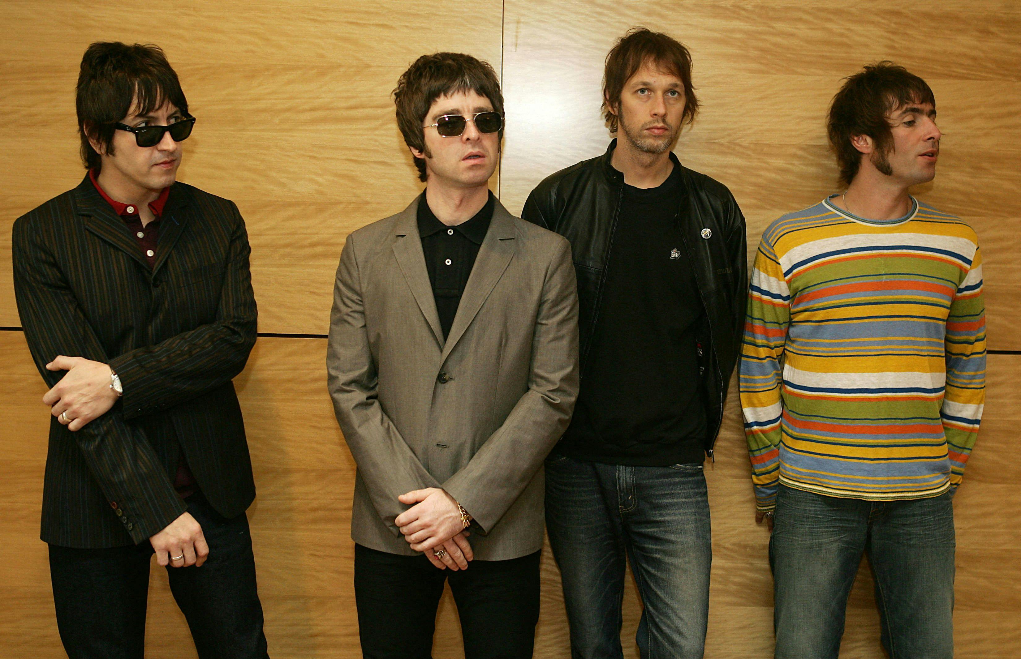 (FILES) Gem (L), Noel Gallagher (2L), Andy Bell (2R) and Liam Gallagher, members of the British rock band "Oasis" hold a photocall in Hong Kong on February 25, 2006. British rock legends Oasis announced on August 27, 2024 they will reunite for a worldwide tour starting in the UK next year, as brothers Liam and Noel Gallagher ended an infamous 15-year feud. (Photo by Mike CLARKE / AFP)