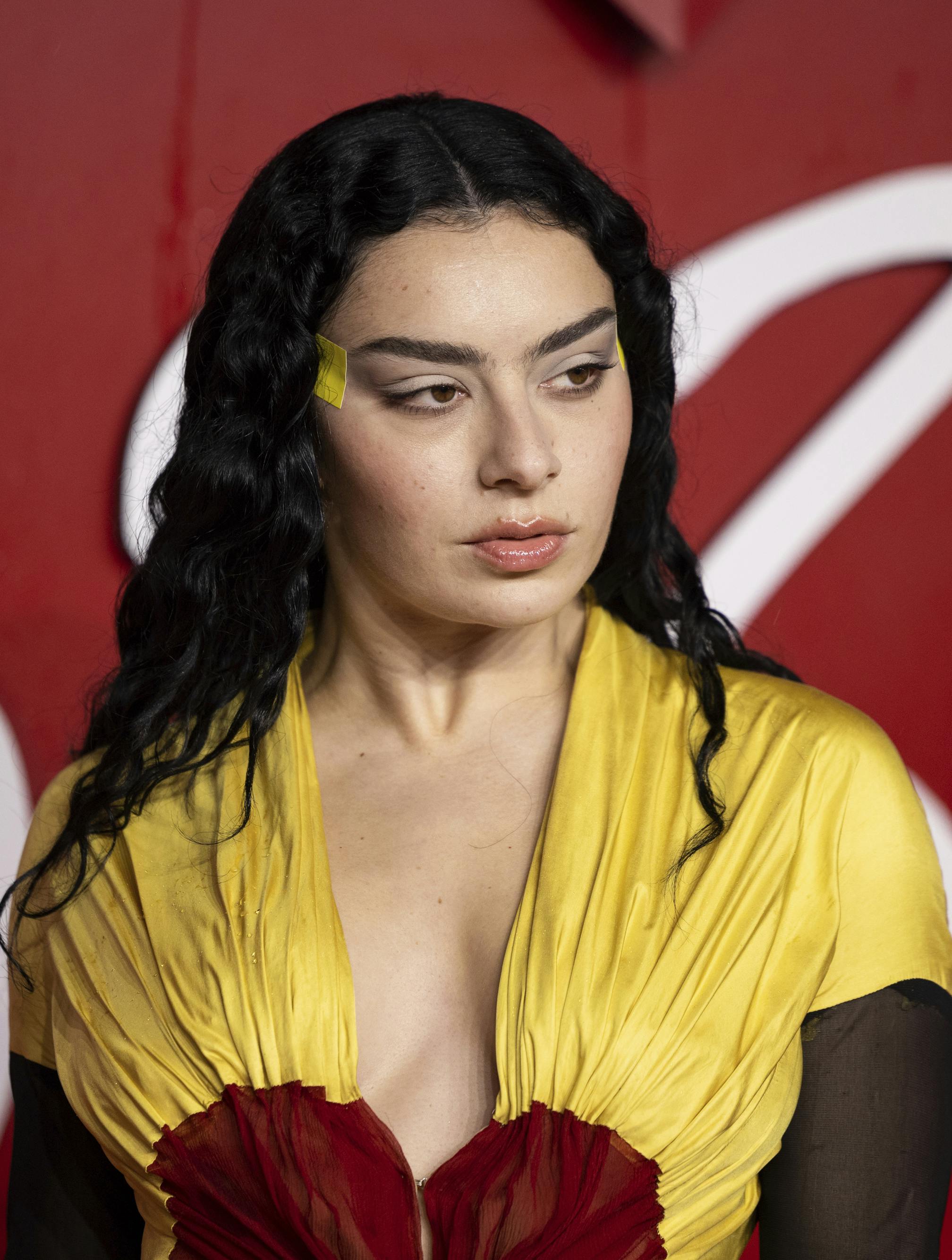 Charli XCX poses for photographers upon arrival at the British Fashion Awards on Monday, Dec. 4, 2023 in London. (Vianney Le Caer/Invision/AP)
