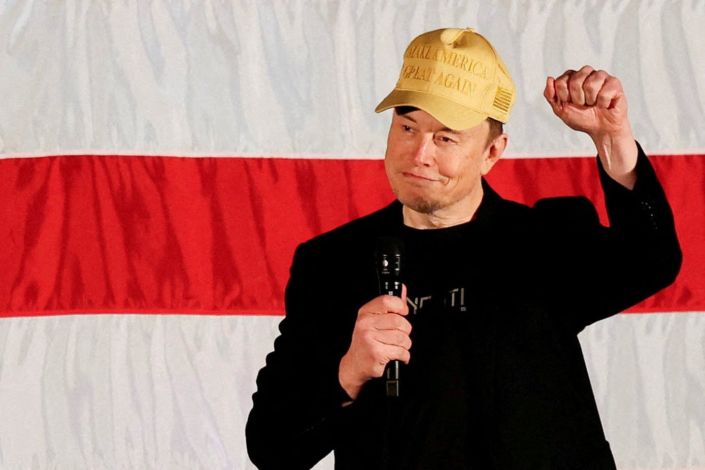 FILE PHOTO: Tesla CEO and X owner Elon Musk, who supports Republican presidential nominee former U.S. President Donald Trump, gestures as he speaks about voting during an America PAC Town Hall in Folsom, Pennsylvania, U.S., October 17, 2024. REUTERS/Rachel Wisniewski/File Photo