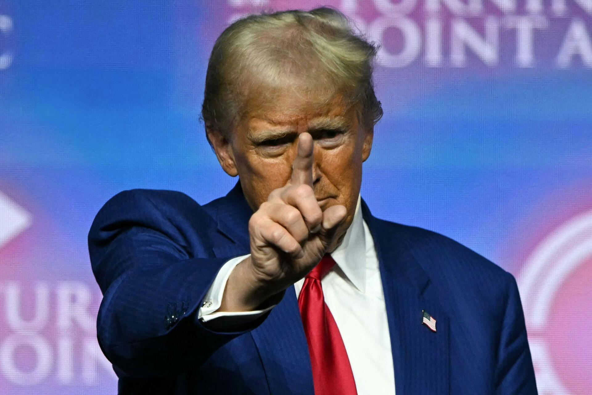 TOPSHOT - Former US President and Republican presidential candidate Donald Trump gestures onstage after speaking during a Turning Point Action 'United for Change' campaign rally in Las Vegas, Nevada on October 24, 2024. (Photo by Patrick T. Fallon / AFP)