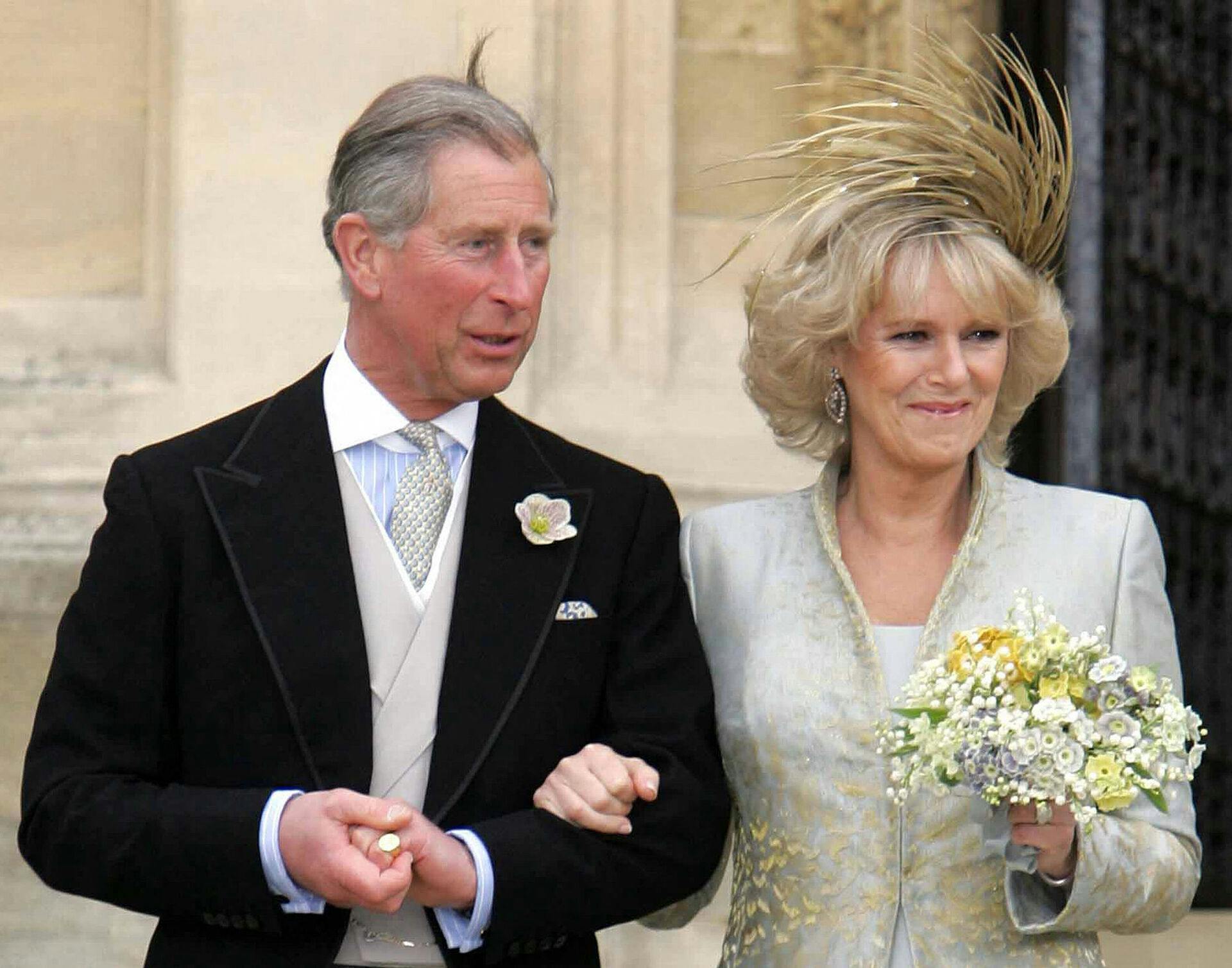 (FILES) In this file photo taken on April 9, 2005 Prince Charles and Camilla, the Duchess of Cornwall leave a blessing at St Georges Chapel in Windsor Castle after their civil wedding. - The coronation ceremony of Britain's King Charles III and his wife, Britain's Camilla, Queen Consort, as King and Queen of the United Kingdom and Commonwealth Realm nations is scheduled to take place at Westminster Abbey, in London, on May 6, 2023. (Photo by POOL / AFP)