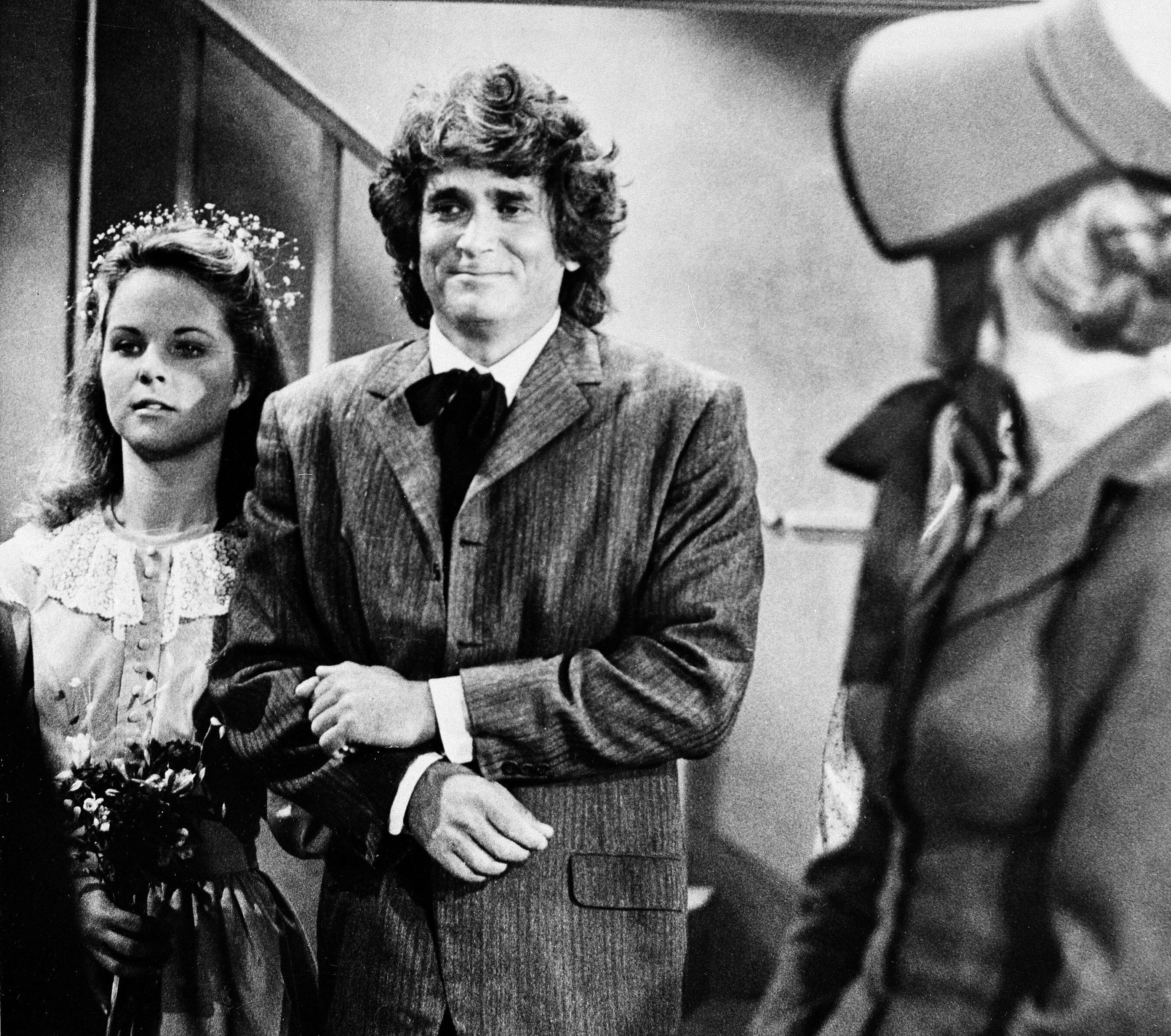 Actress Melissa Sue Anderson, left, who plays Mary for the television series " Little House on the Prairie" is escorted by actor Michael Landon, who plays her father, are shown during the taping of Mary's wedding scene in Los Angeles, Calif. Sept. 11, 1978. (AP Photo/Huynh)