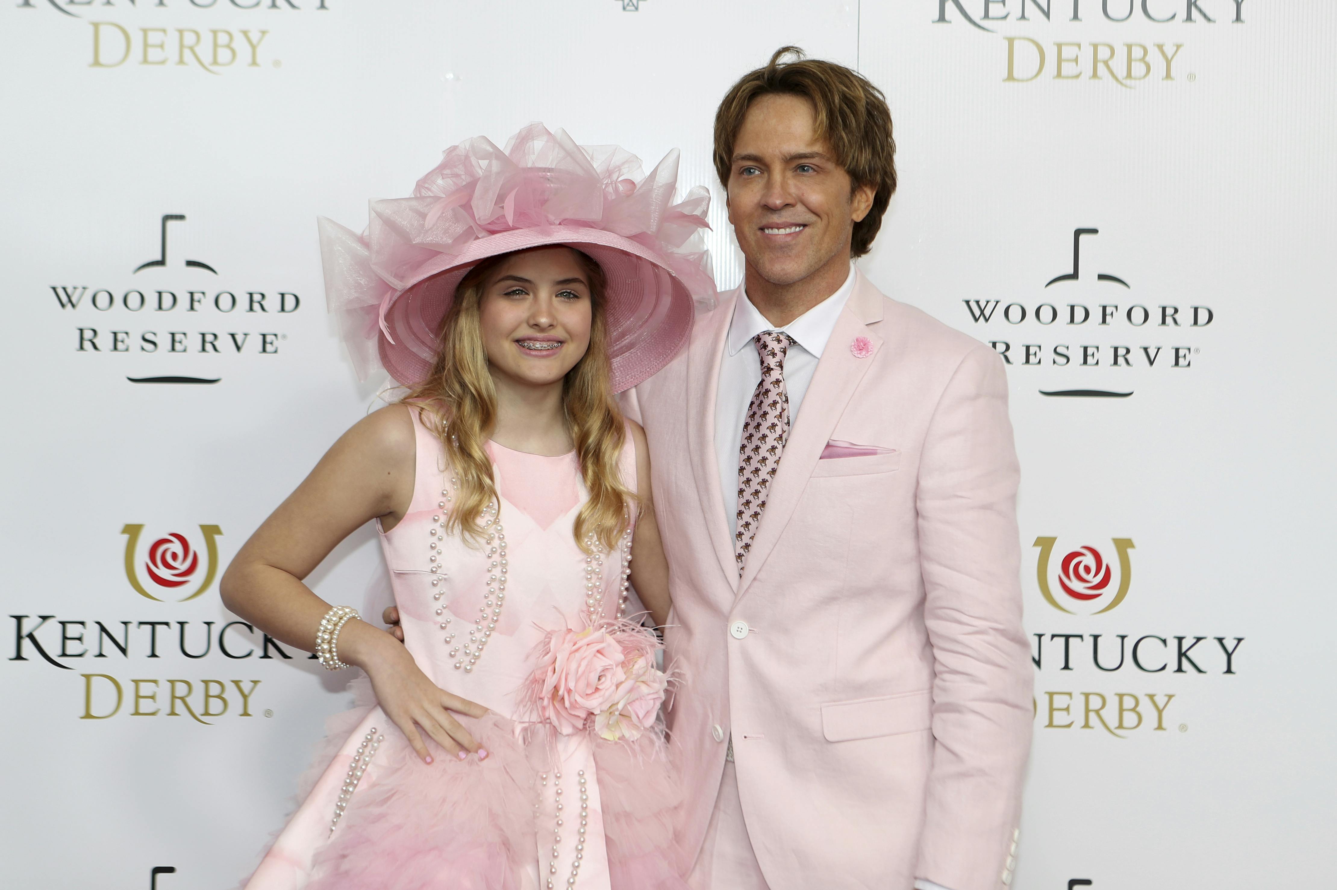 Larry and Dannielynn Birkhead walk the red carpet before the 145th running of the Kentucky Derby horse race at Churchill Downs Saturday, May 4, 2019, in Louisville, Ky. (AP Photo/Gregory Payan)