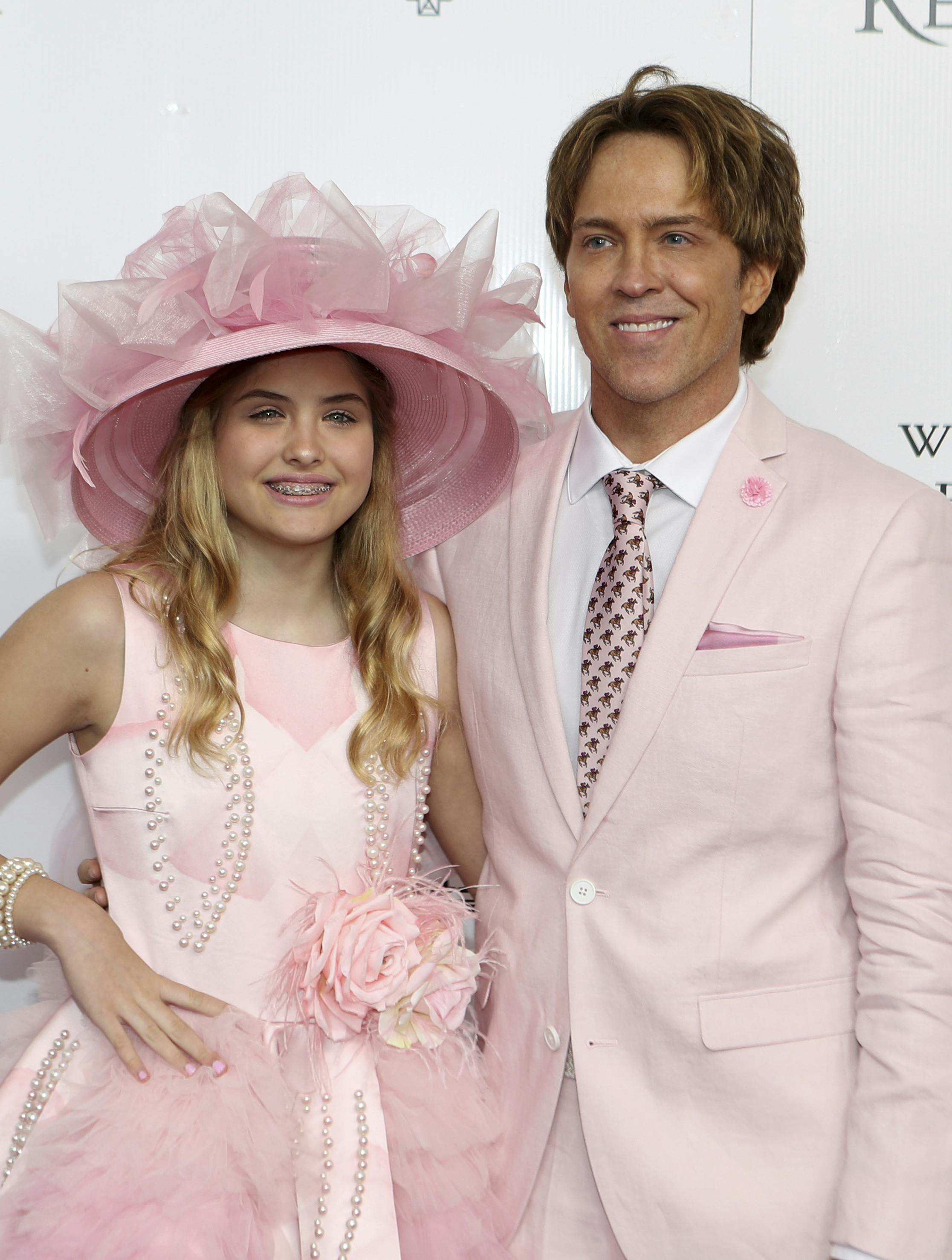 Larry and Dannielynn Birkhead walk the red carpet before the 145th running of the Kentucky Derby horse race at Churchill Downs Saturday, May 4, 2019, in Louisville, Ky. (AP Photo/Gregory Payan)