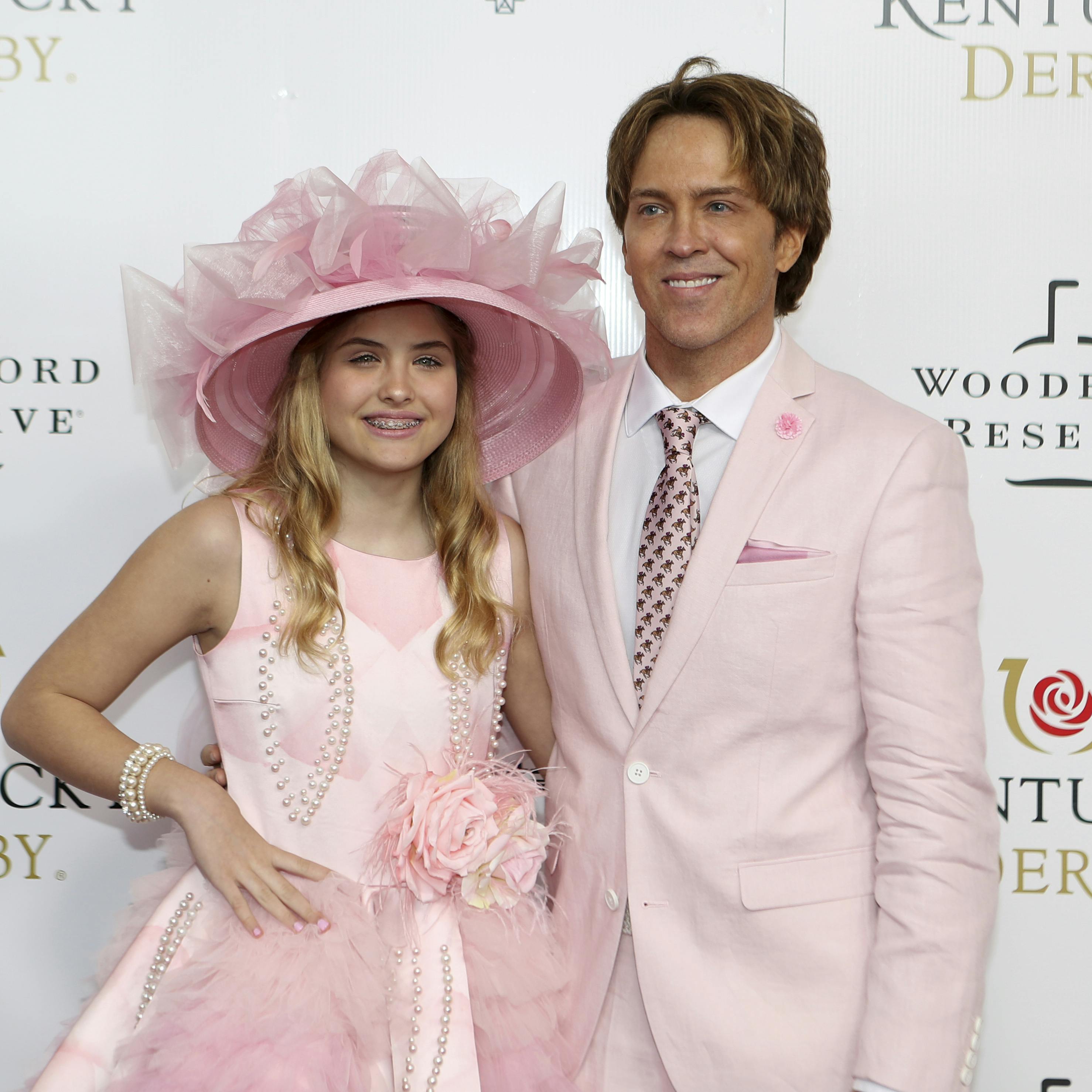 Larry and Dannielynn Birkhead walk the red carpet before the 145th running of the Kentucky Derby horse race at Churchill Downs Saturday, May 4, 2019, in Louisville, Ky. (AP Photo/Gregory Payan)