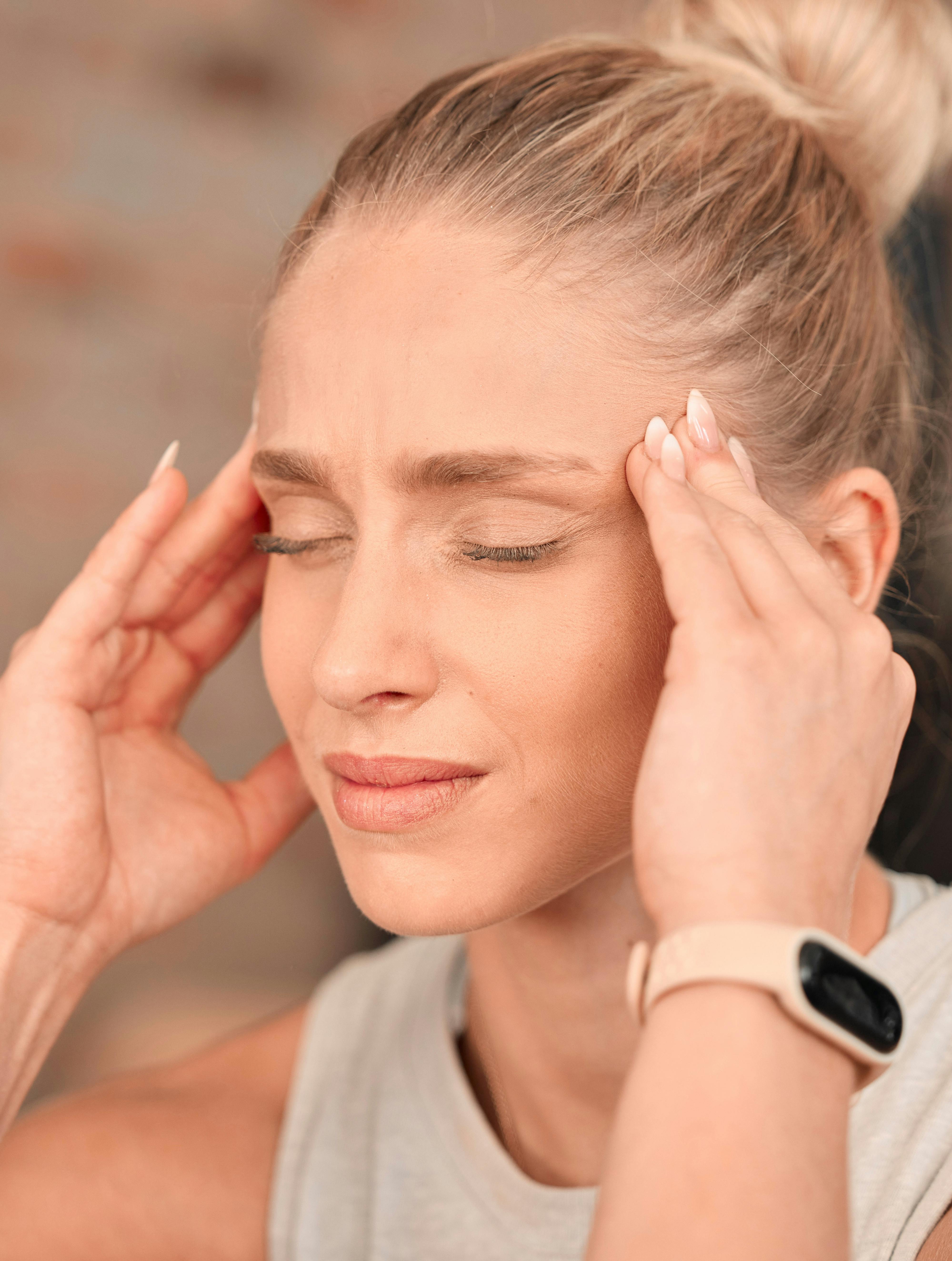 Woman, headache and pain at gym for fitness, exercise anxiety and workout challenge. Face of female athlete with migraine, sports injury and frustrated in struggle of training problem, sick and tired.