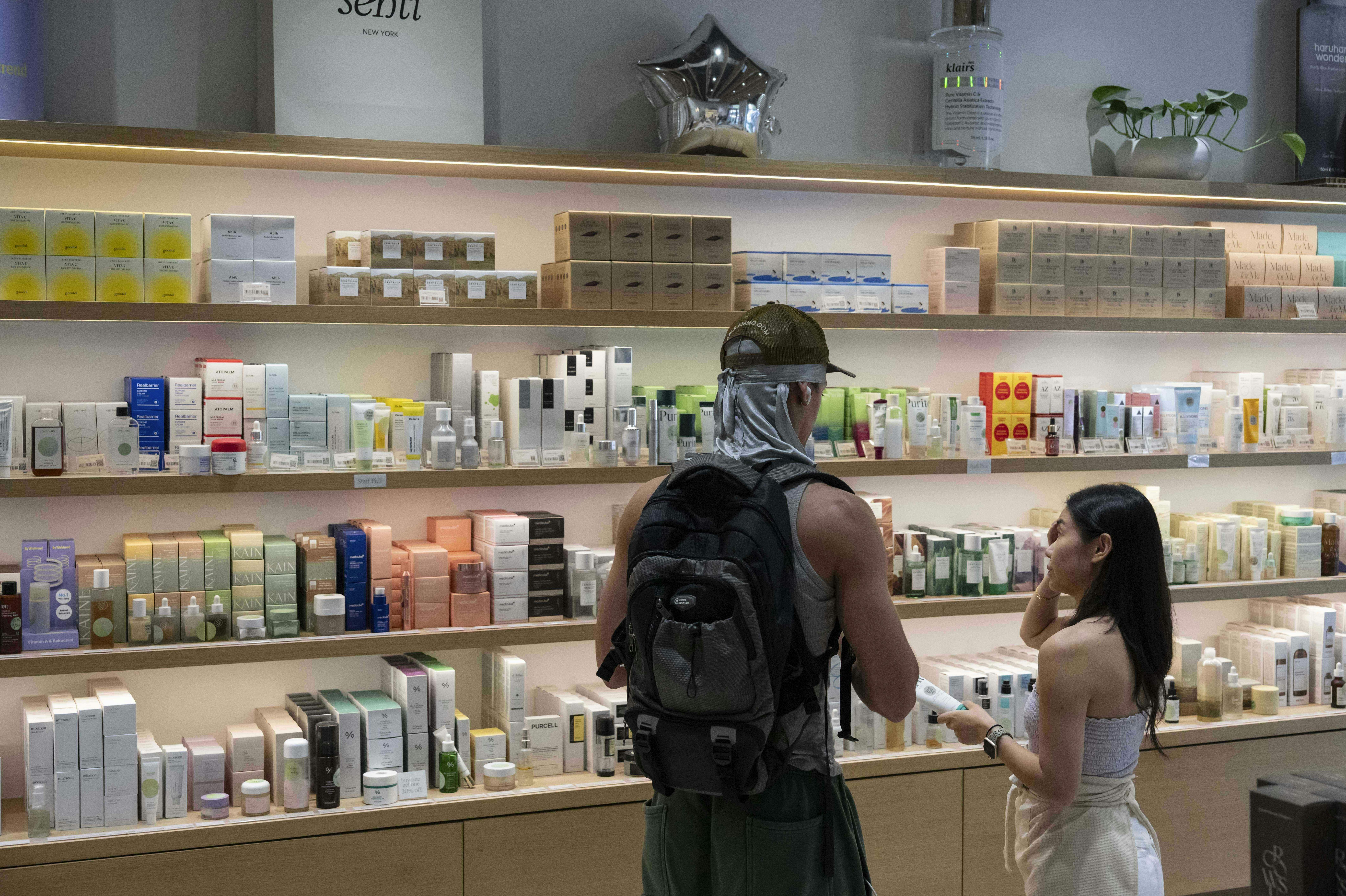 A customer checks Asian beauty products at a Senti Senti store in New York on Friday, July 25, 2025. (AP Photo/Yuki Iwamura)