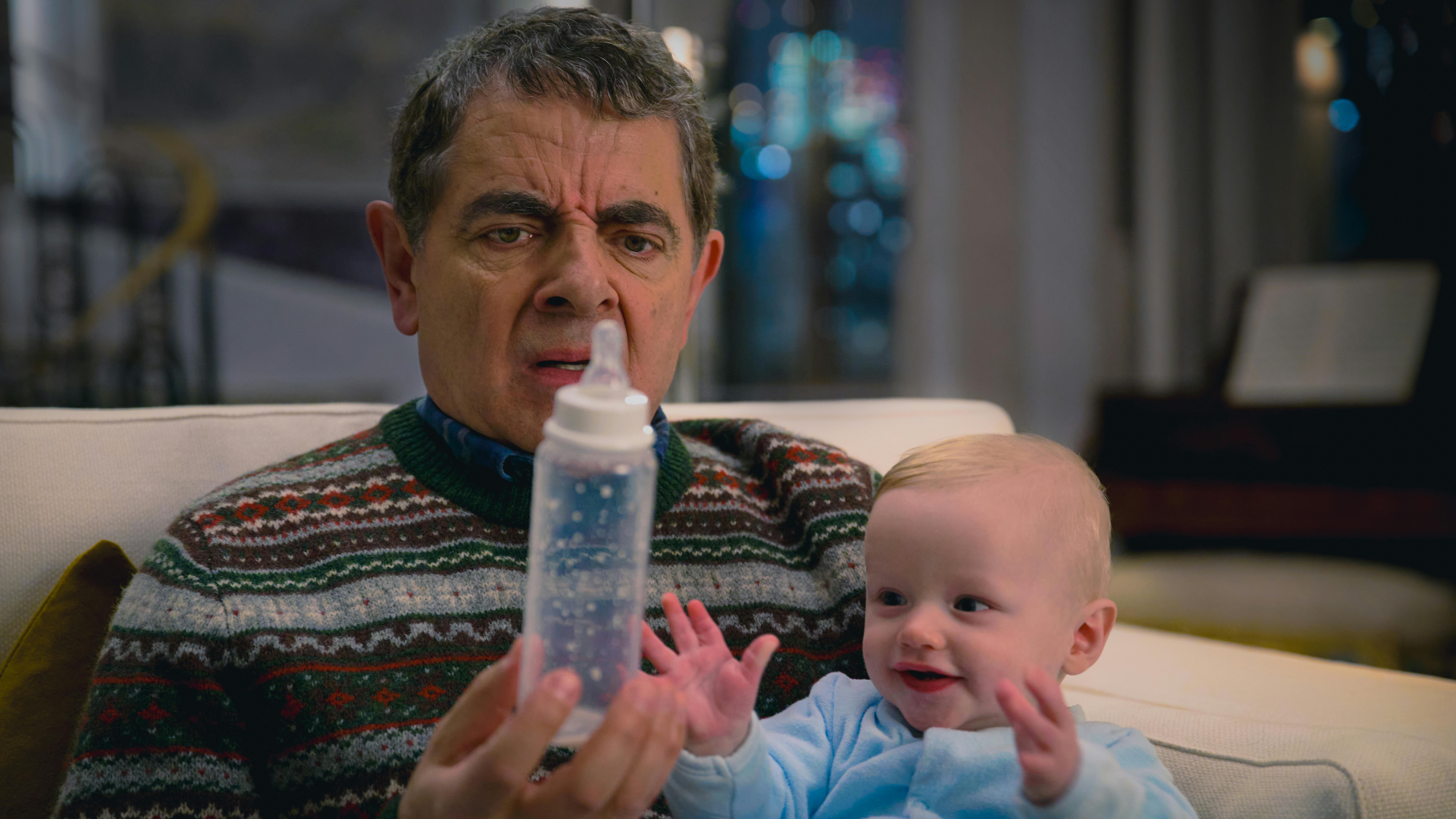 Man Vs Baby. (L to R) Rowan Atkinson as Trevor Bingley, Baby Jesus, in Man Vs Baby. Cr. Courtesy of Ana Blumenkron/Netflix © 2025