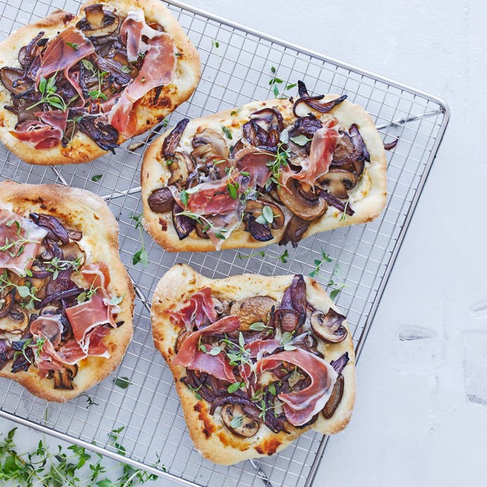 Mini-pizzaer med gedeost, svampe og sortfodsskinke 