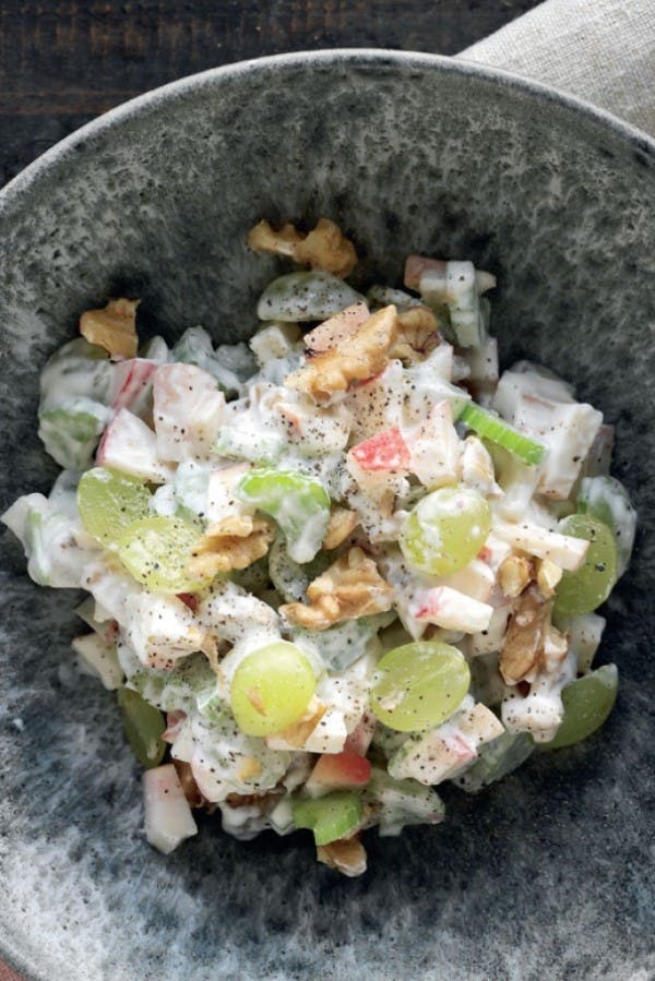 Server en lækker waldorfsalat med æbler, valnødder og vindruer til din julefrokost med denne opskrift